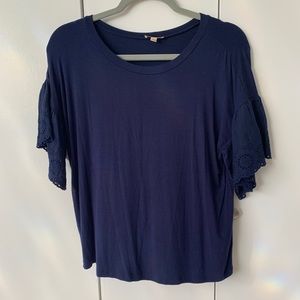 Blue shirt with lace-like detail on sleeves